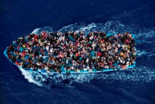 Operation Mare Nostrum. Shipwrecked aboard a boat are rescued 20 miles north from Libya by the frigate FREMM Bergamini of the Italian Navy